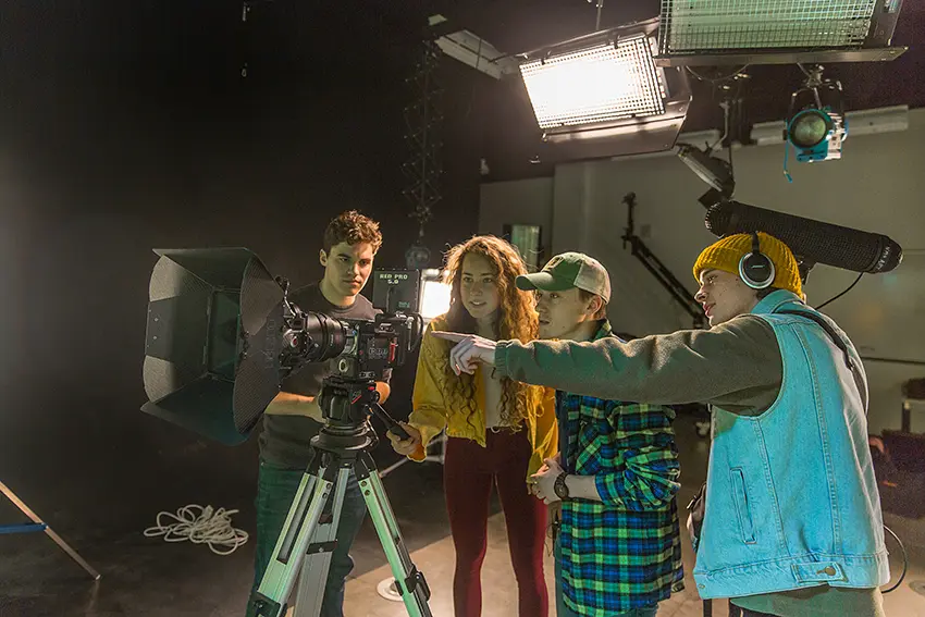 Four numeric cinema students working in a production lab at Northern Michigan University.